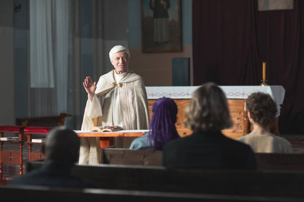 istock Priest blessing the people in the church 1314577223