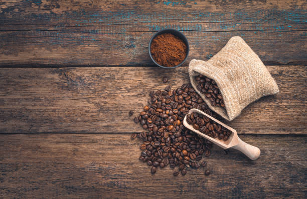 istock Ground coffee and coffee beans on a wooden brown background 1314577586