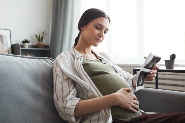 istock A woman sitting on a couch reading a book 1314577748