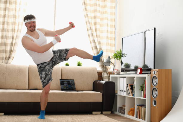 istock Fat man in sportswear and dumbbells does physical exercise 1314578045