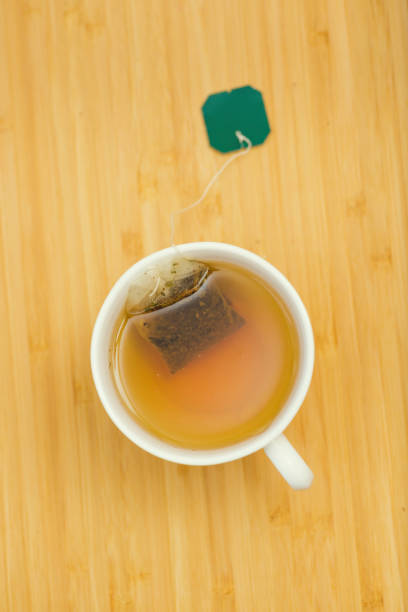 istock tea bag is brewed in a white mug with hot water 1314578096