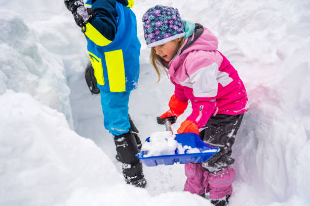 istock Girl and boy shoveling snow 1314579397