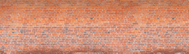 Brick tile wall abstract background. Exterior view of a house made of blocks lined with cement. Exterior wall made of decorative brickwork.