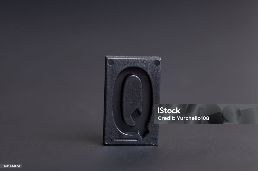 Letter Press Q on black background Letter Press Q on black background. Abstract Stock Photo