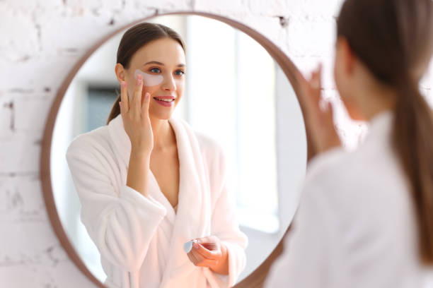 istock Young woman applying eyes patches in bathroom 1314583873