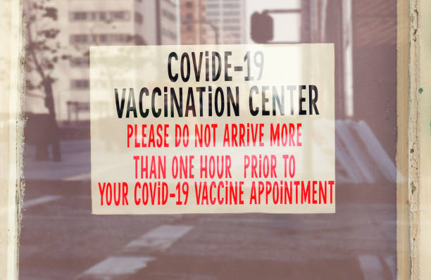 istock hanging covid-19 vaccination center note through window 1314586079