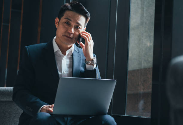 istock Serious businessman talking on mobile phone and looking at camera 1314586165