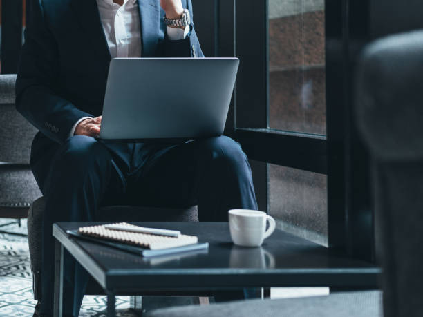 istock Unrecognizable businessman sitting in cafe and using laptop 1314586182