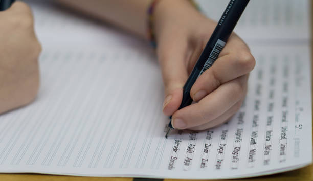 istock Left handed girl doing homework 1314586243