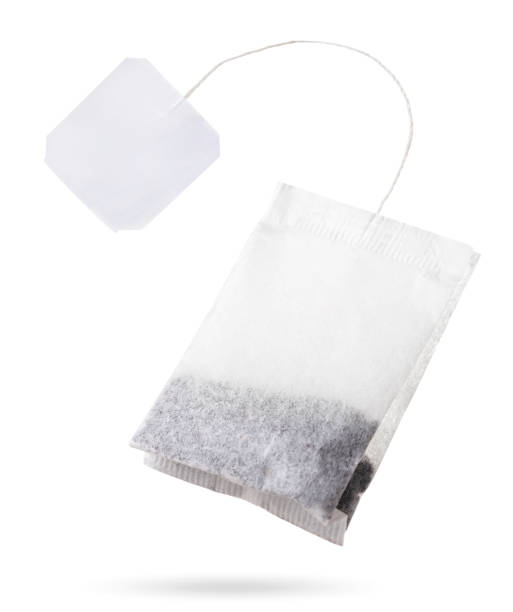 istock Teabag with white label flies on white background, isolated. Tea bag mockup 1314588240