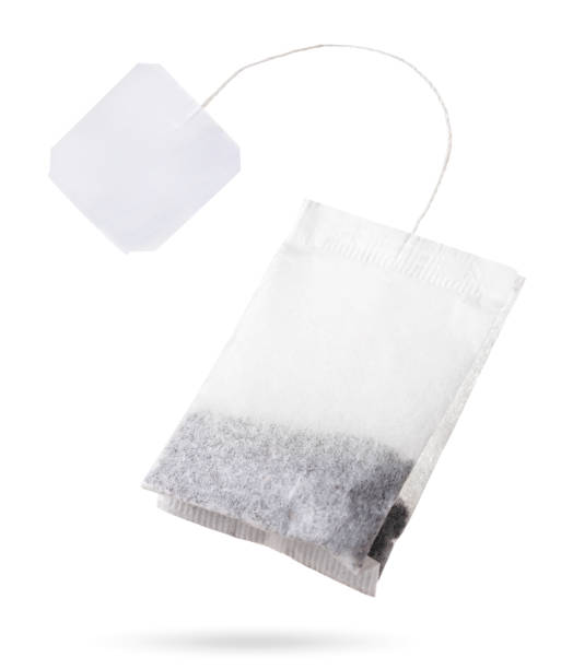 teabag with white label flies on white background, isolated. tea bag mockup - teabag label blank isolated imagens e fotografias de stock