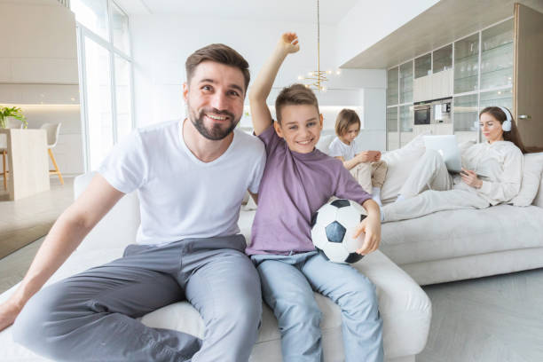 istock Father and son watching soccer 1314589172