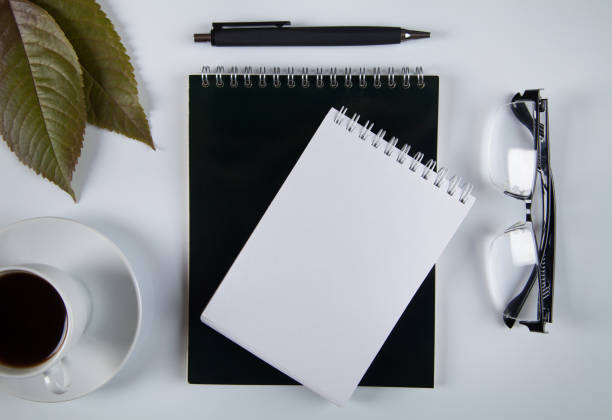 istock Notebook, pen, glasses and coffee, white background. 1314589786
