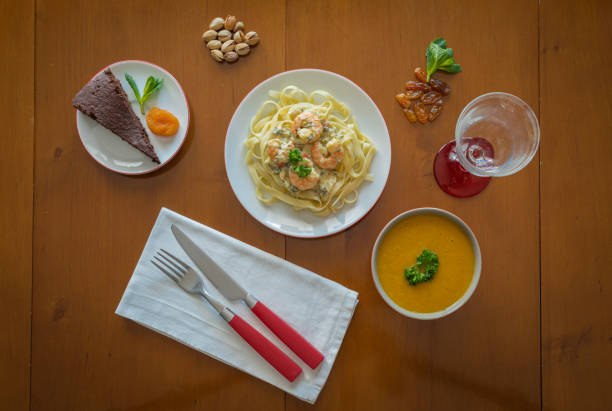 paris, france: creamed shrimp pasta, vegetable soup and vlice of chocolate served on a table - sweet sauce tablespoon food sweet food imagens e fotografias de stock