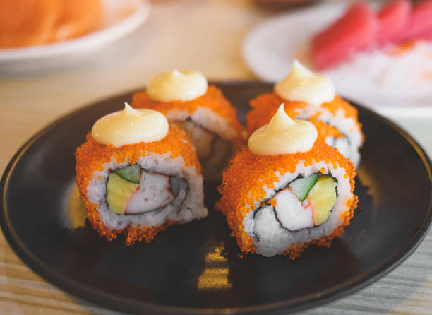 istock California roll and cut served in black plate. 1314592129