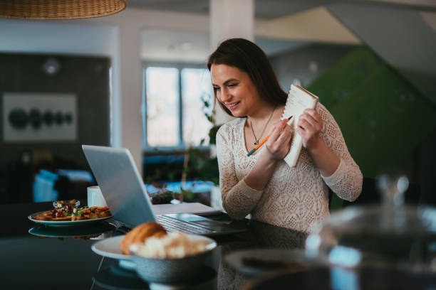istock Woman using laptop and having a video call working from home 1314592413