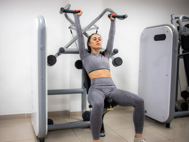istock Young female athlete exercising in gym with weights 1314593166