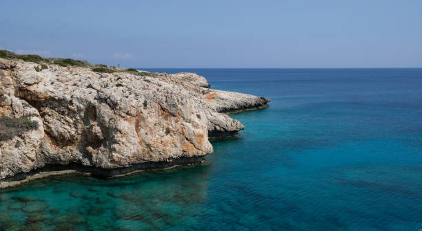 istock Rocky coastline with blue water and sky. 1314595321