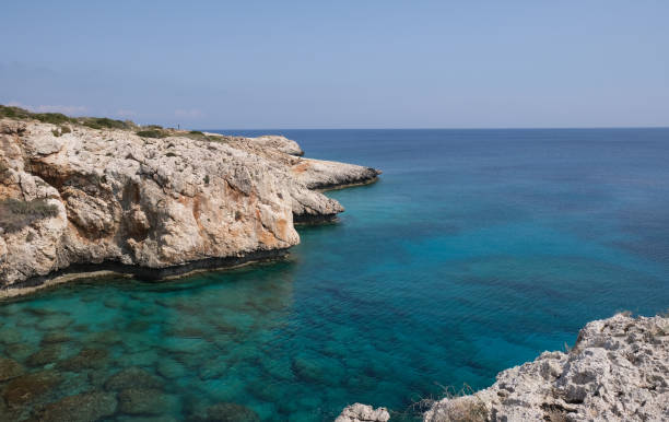 istock Rocky coastline with blue water and sky. 1314595326