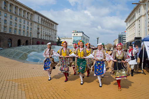 Beautiful young people in traditional Bulgarian costumes, presented doing various activities.