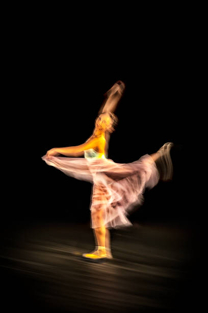 istock Ballerina is dancing black background 1314597264