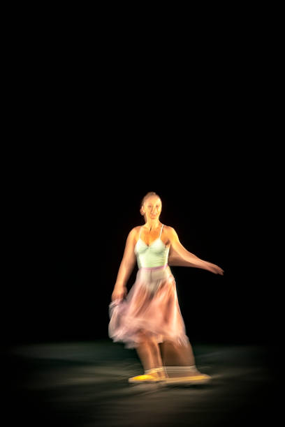 istock Ballerina is dancing black background 1314597371