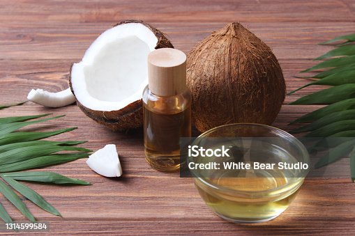 istock coconut oil and coconuts, palm branches close up 1314599584