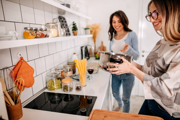 istock Delighted friends cooking spaghetties 1314601278