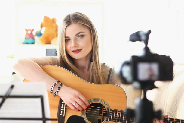 istock Woman is recording guitar playing on camera 1314602121
