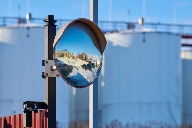 Convex mirror of spherical type on pole reflecting road Mirror of spherical type on telegraph pole reflecting road. Large convex mirror on road for improving visibility. Convex mirror for roadside safety. Traffic curved glass. convex stock pictures, royalty-free photos & images