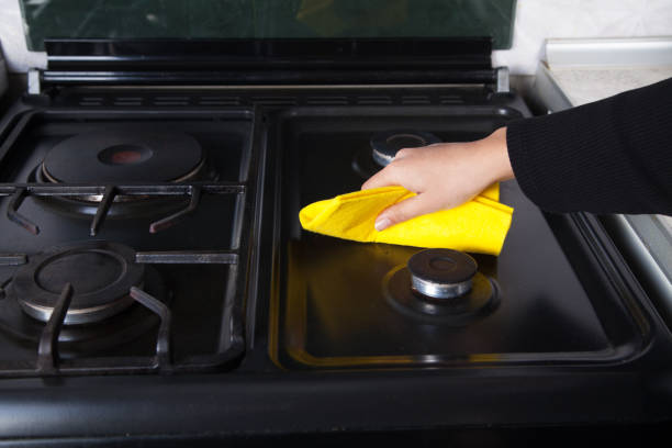 istock Woman cleans the kitchen gas with a cloth. 1314604118