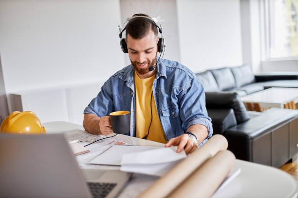 istock Young man working on his laptop and drinking coffee at home office 1314604563