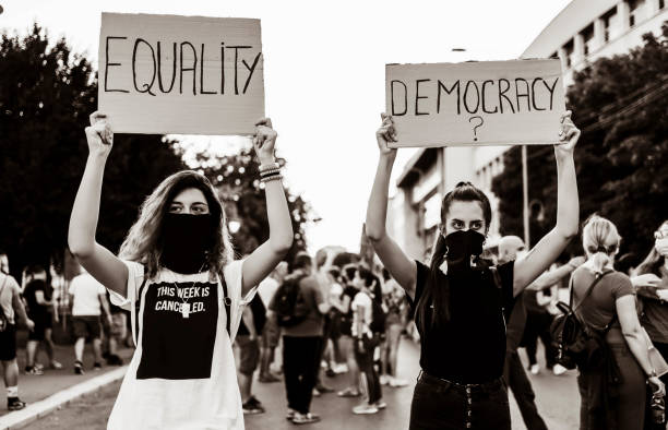 istock Young women protesters holding placards 1314604613