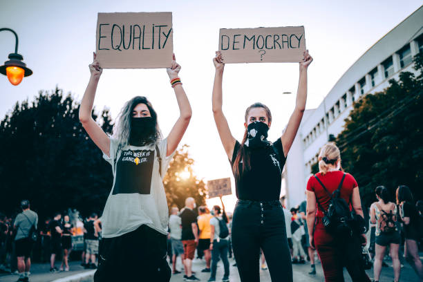 istock Young women protesters holding placards 1314604741