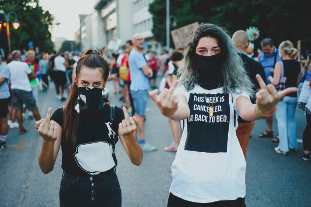 istock Young female protesters showing middle finger 1314604791