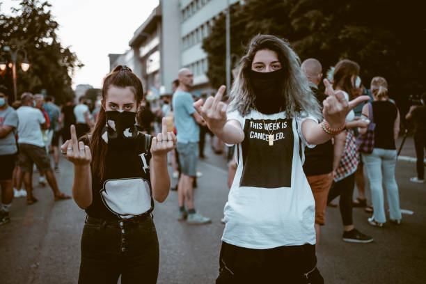 istock Young female protesters showing middle finger 1314604916