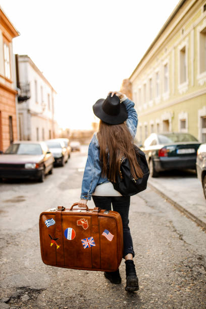 istock Back of unrecognizable tourist with suitcase 1314606289