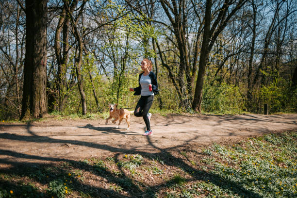 istock Sportswoman jogging with dog 1314609295