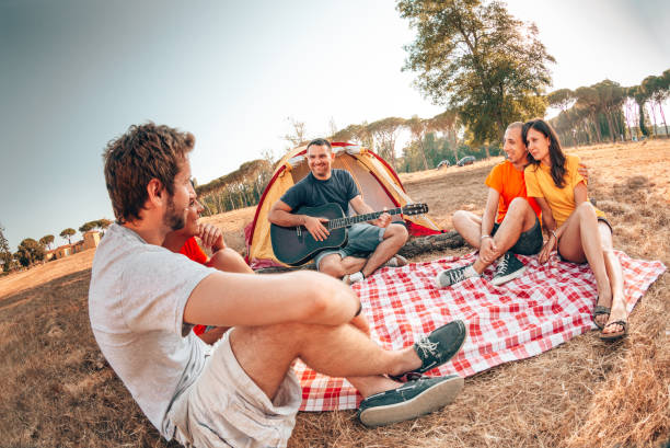 istock playing the guitar at the camping 1314613209