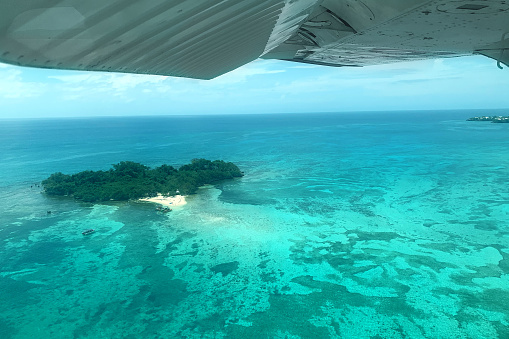 Overhead view of a small island off the coast of Negril, Jamaica from a small plane.