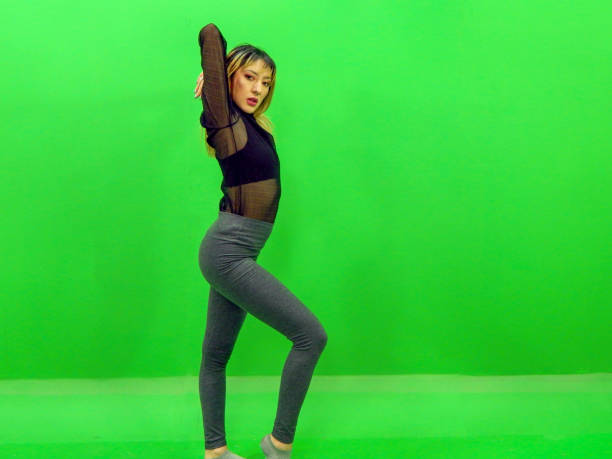 istock Woman exercising with green background 1314616288