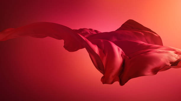 istock 3d render. Abstract fashion background with silk cloth. Dramatic scene with red drapery blown away by the wind 1314616667