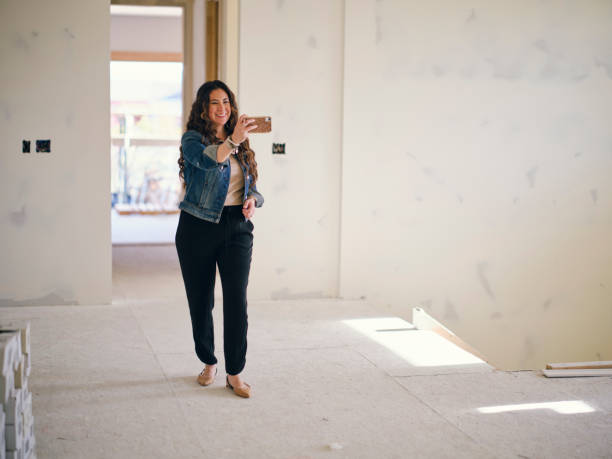 istock Woman Looking at a Home Under Construction 1314617970