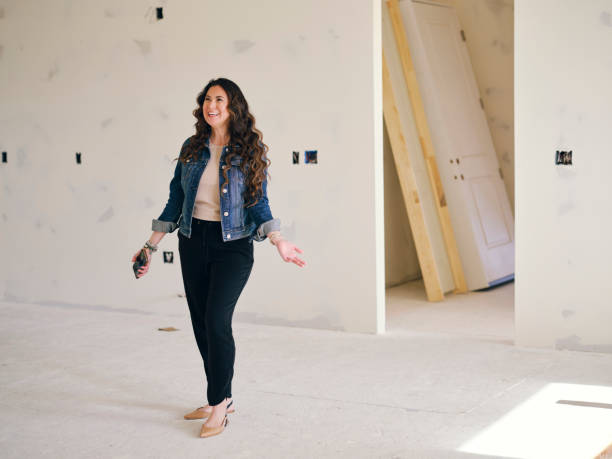 istock Woman Looking at a Home Under Construction 1314617983