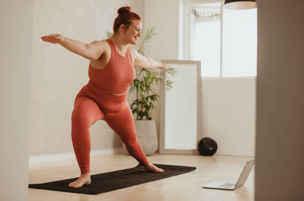 istock Woman exercising with watching workout class online on laptop 1314618036
