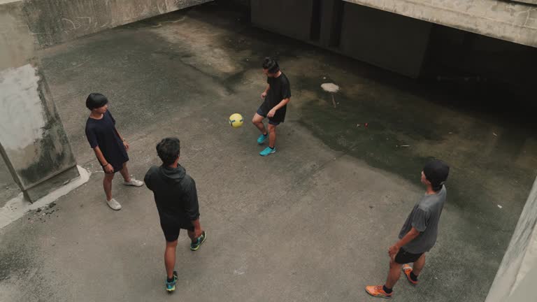 Young asian man playing football