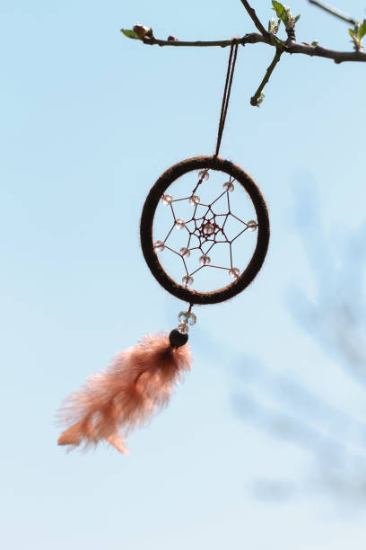 istock Dreamcatcher with crystal beads on the sky background. 1314619869
