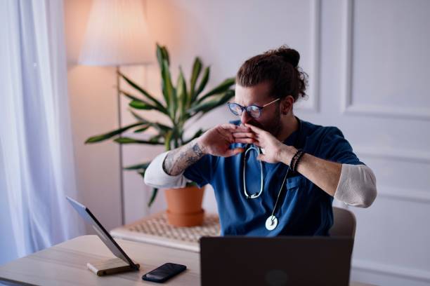 istock Tired doctor working late in his office 1314620251