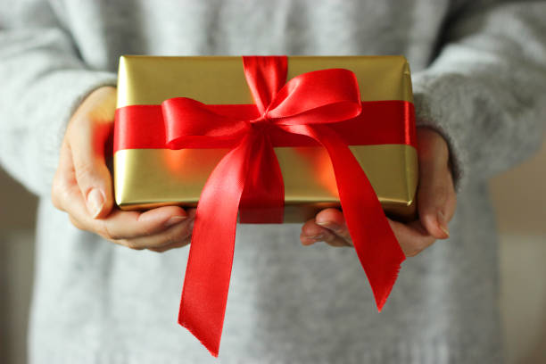 istock gift box in female hands. Holiday, give, gift. 1314622783