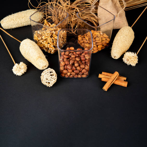 istock Mixed nuts in a glass jar on black background 1314628350